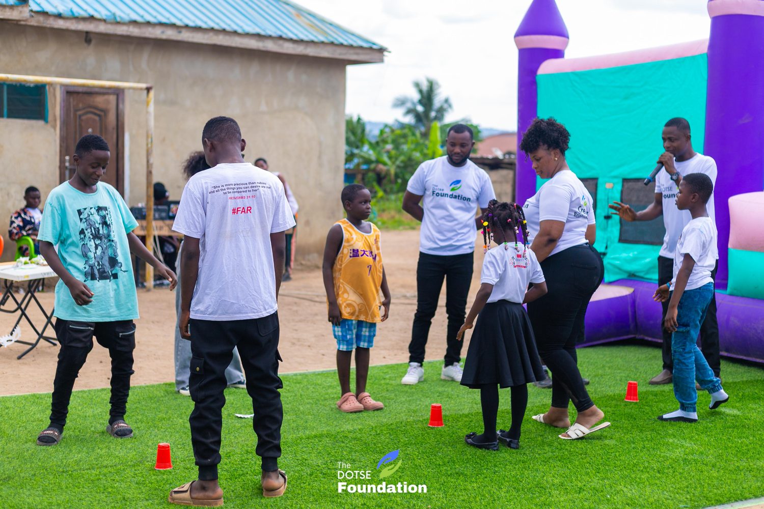 Volunteers and children playing games on the field