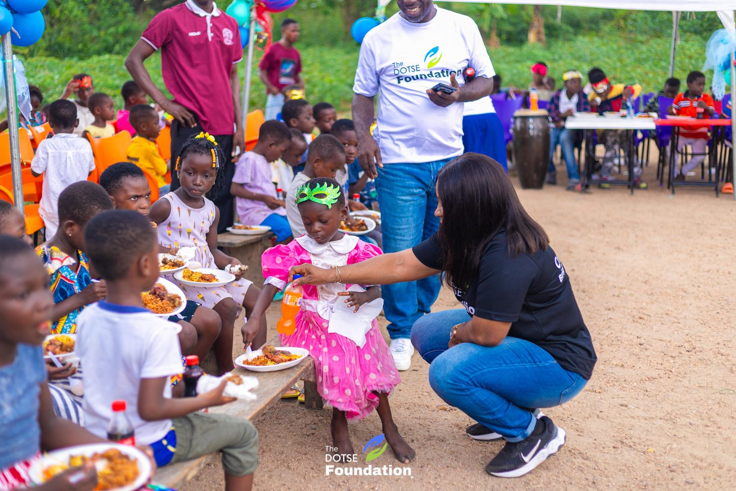 A volunteer serving food to the children